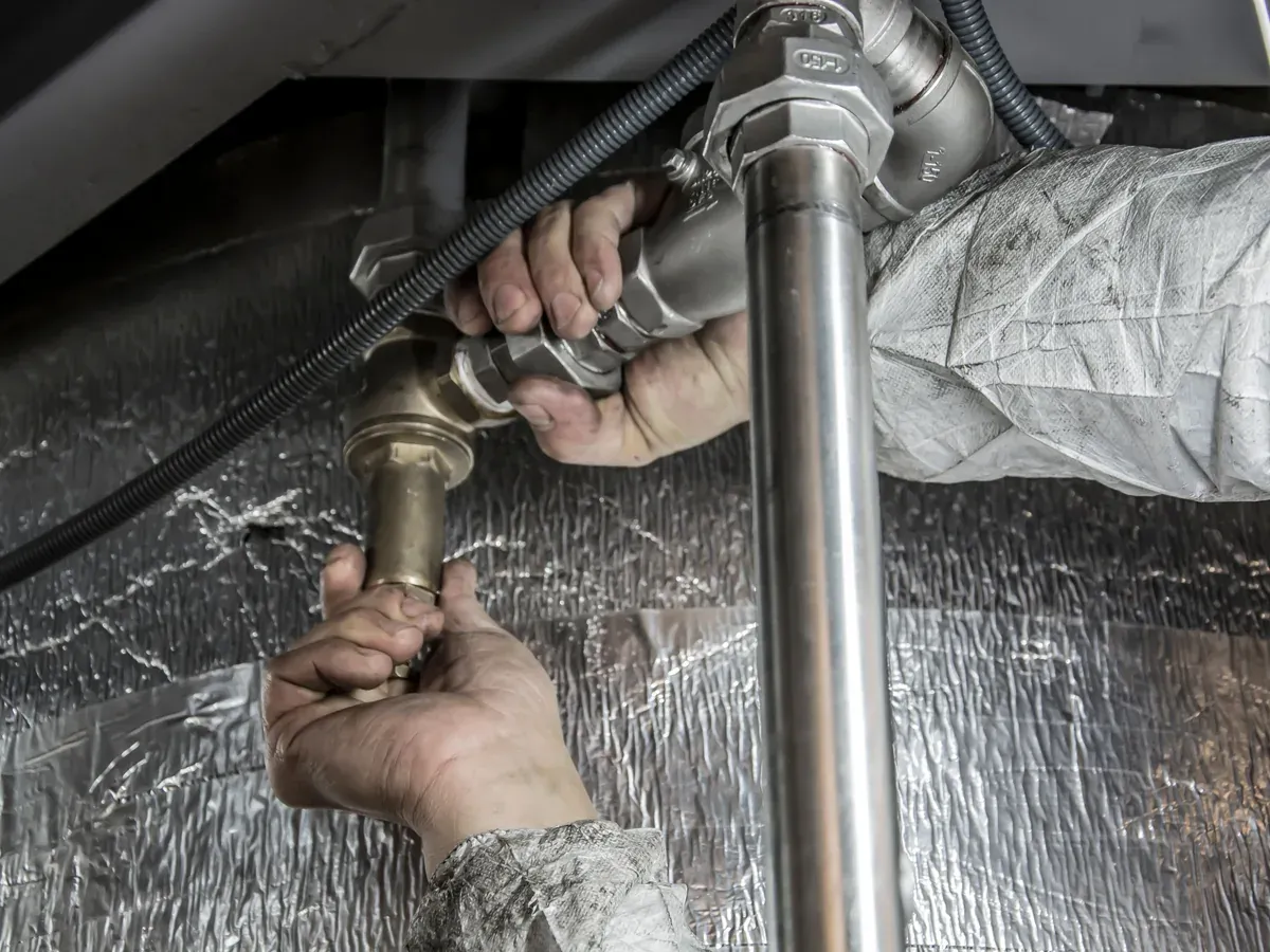 Close-up of professional plumbing work on connected water pipes