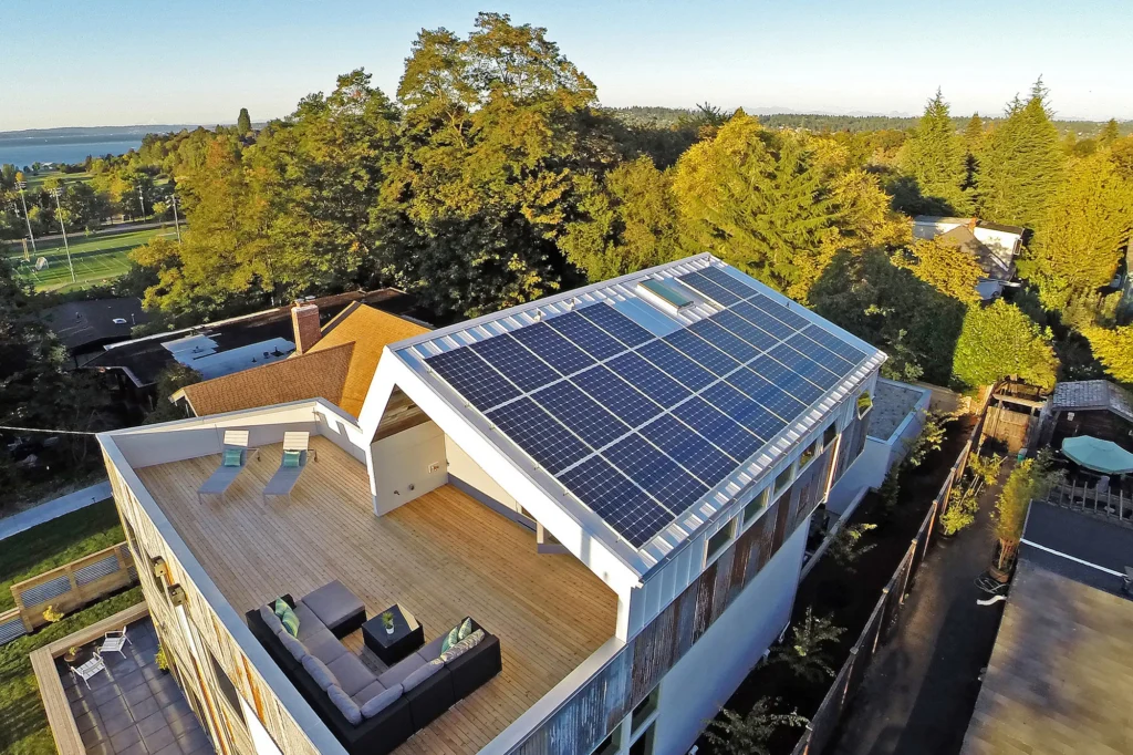 Modern home roof with solar panels and an energy-efficient inverter AC system in Pakistan.